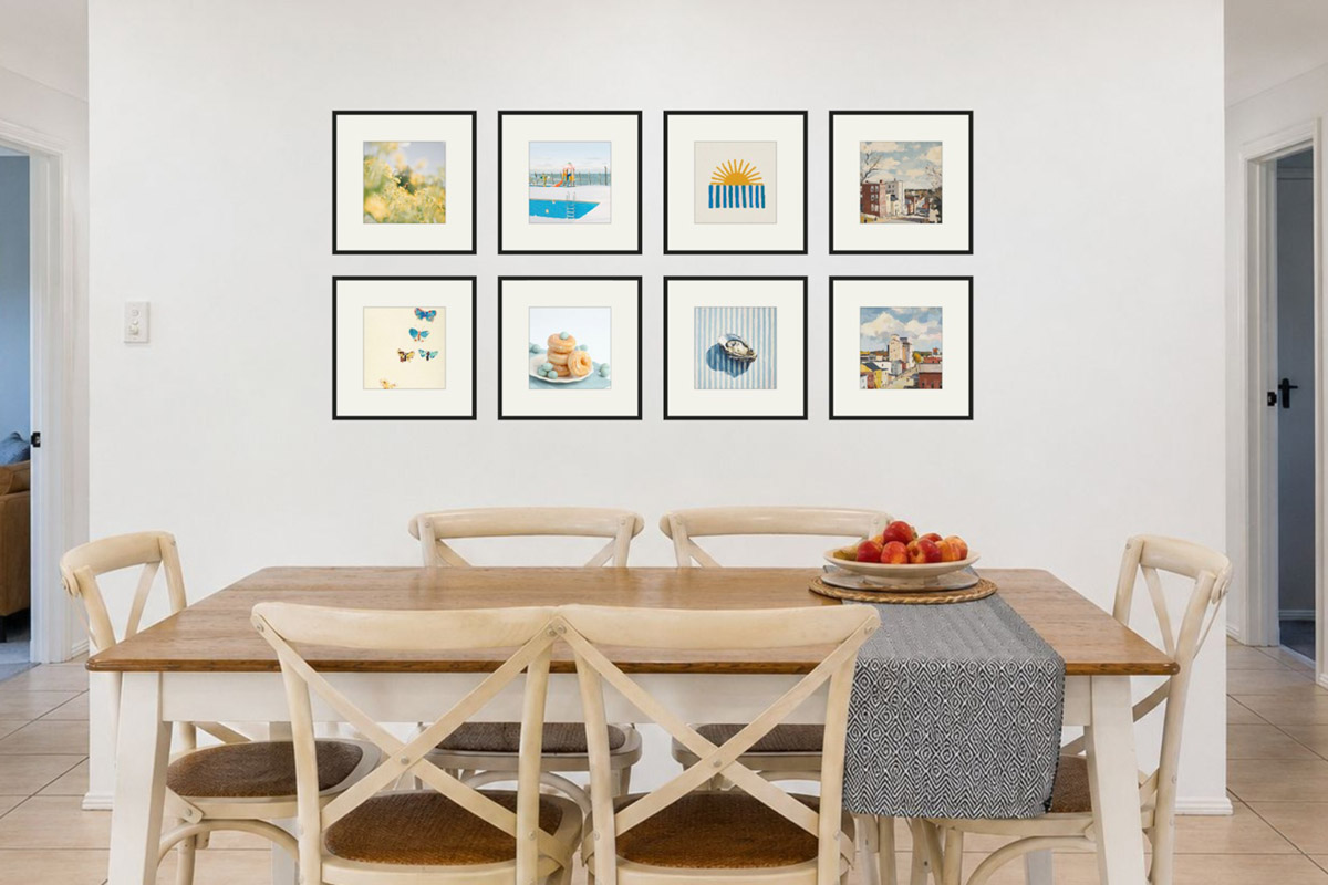 A dining open wall arranged by theme: food, coastal, botanical, and still-life prints in warm tones grouped together